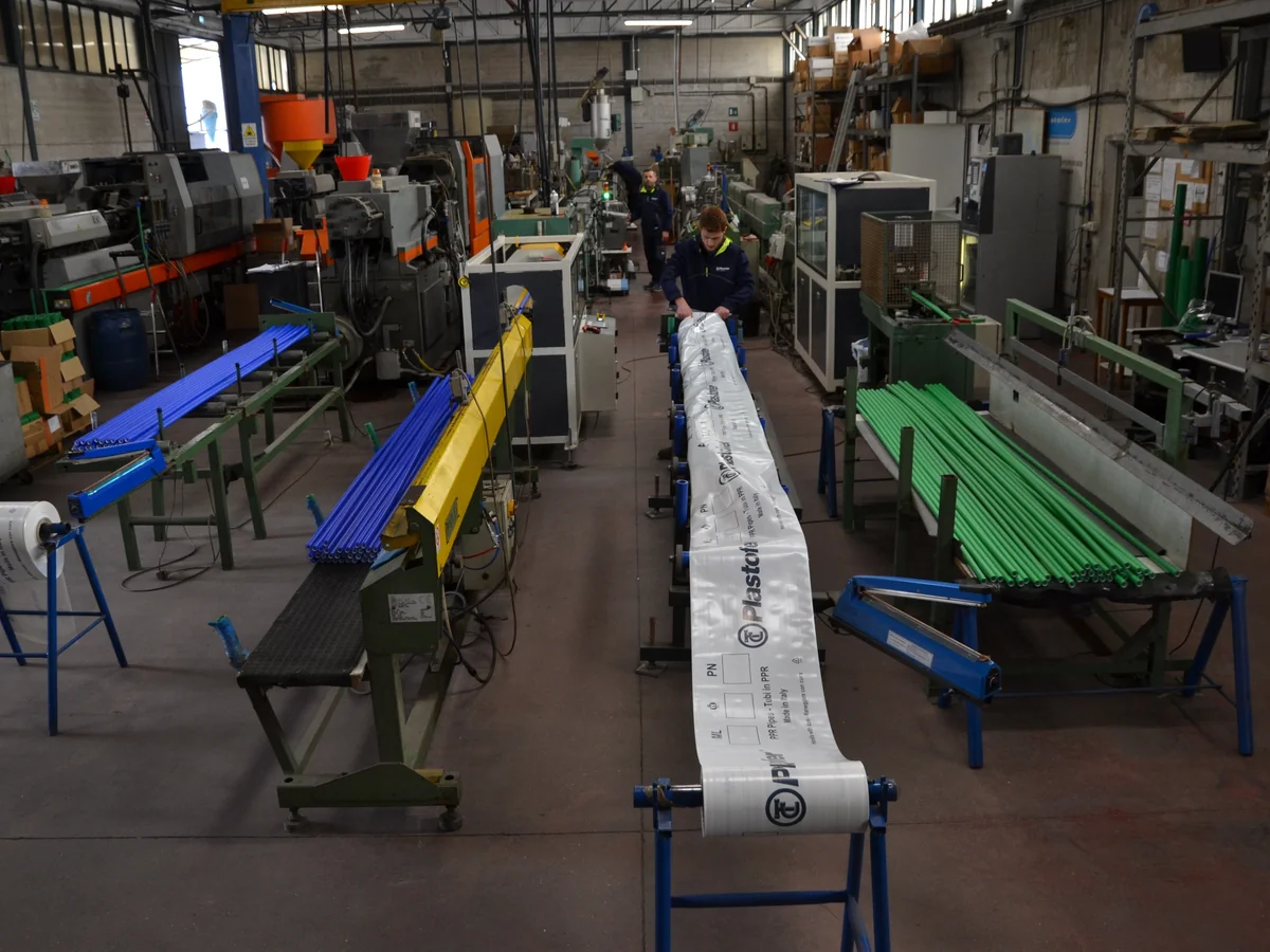The Plastofer workshop, extrusion lines with green and blue PP-R pipes